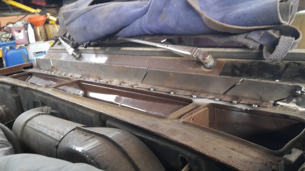 Tacked along bottom edge. Had to cut vertical slots to allow pannel to follow firewall shape