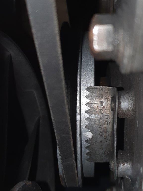 Pulley on car.  Large notch in white.  Smaller notch just in shot at the top of the picture (marked in black)