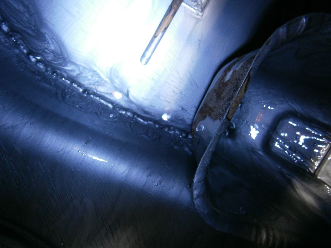 Looking inside the tank after treatment. Thick silver coating, almost plastic and claimed to be impervious to every known solvent. A bit ended up on the shed floor and I reckon it is indestructible !