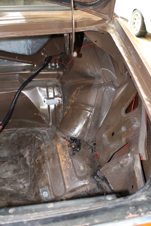 Damage from inside boot. All panels affected, worst is wheel arch. Battery straps held that in place but it moved that much that one of the terminals was ripped out, spilling acid everywhere